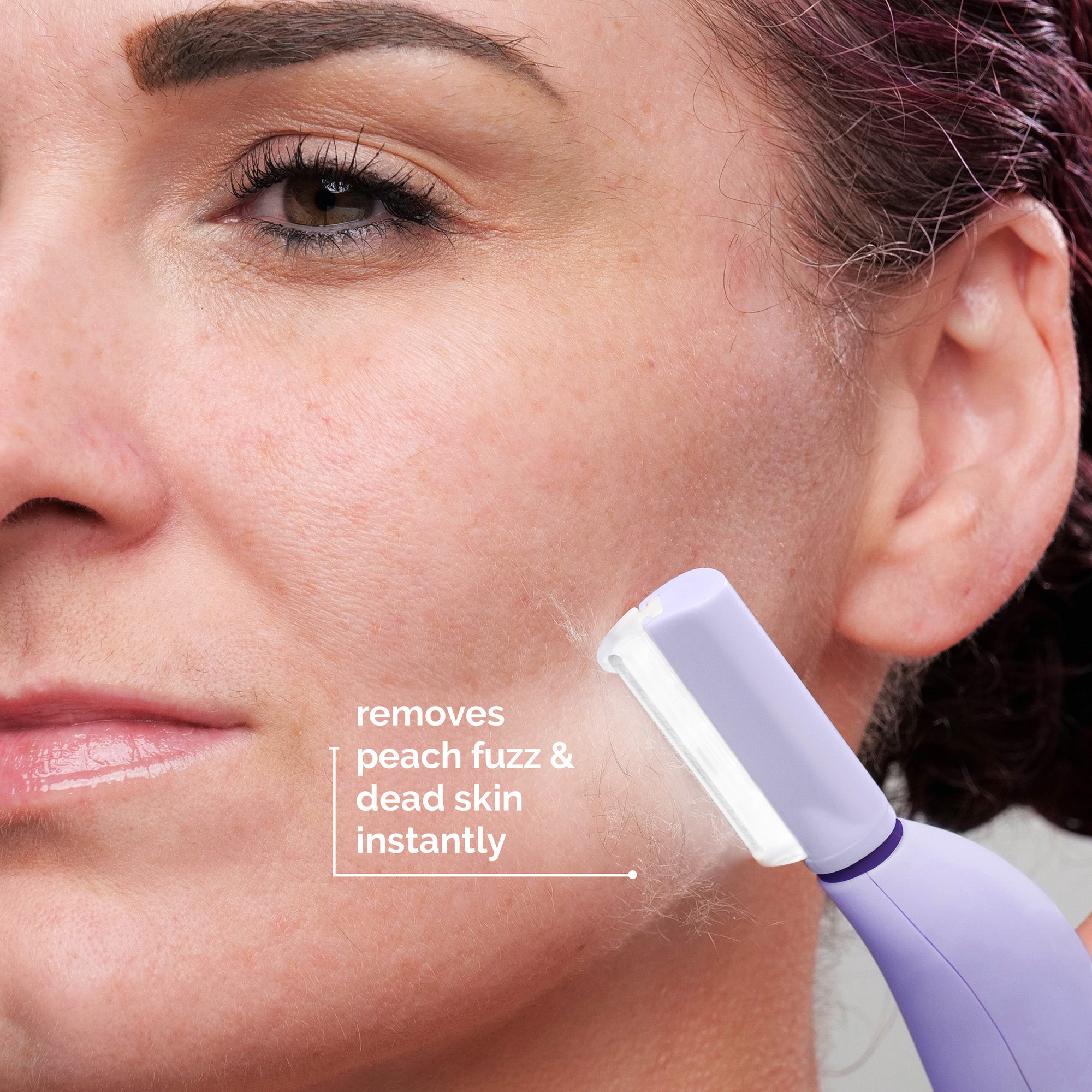 Lavender Lust . Close-up of a woman using a Sonicsmooth Pro+ by Michael Todd Beauty on her cheek, with text describing the device's function of removing peach fuzz and dead skin.