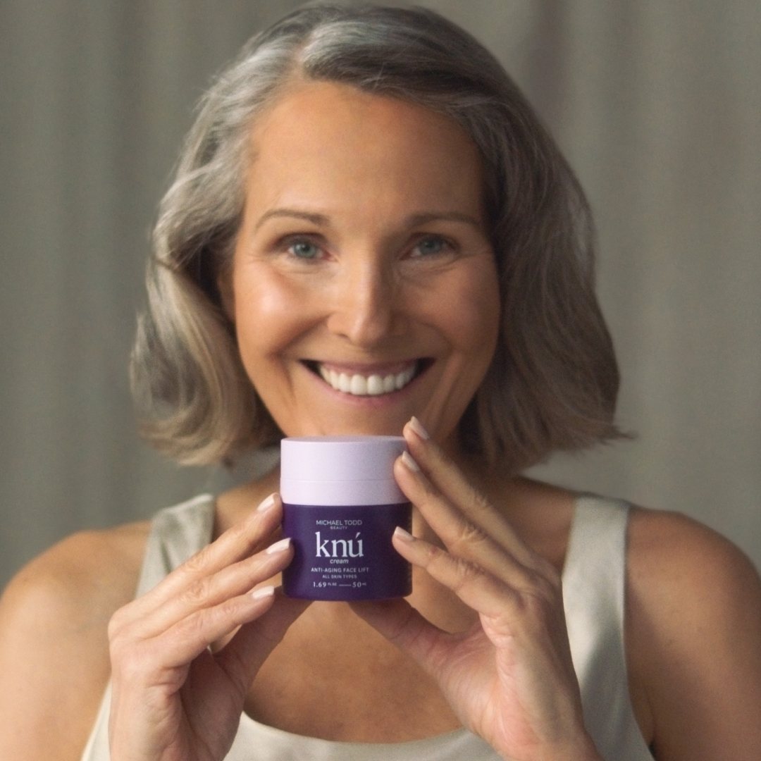 A woman displaying a jar of Knú Cream by Michael Todd Beauty.