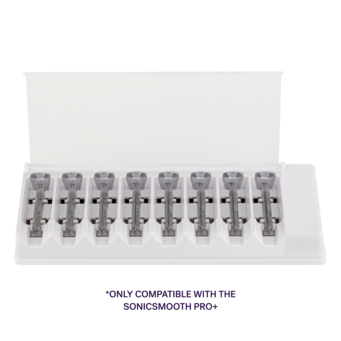 A white tray holds eight grey Sonicsmooth Pro+ Clear Refill Tips from Michael Todd Beauty, lined up in individual slots. Text below reads, "Only compatible with the Sonicsmooth Pro+ and includes Single-Use Safety Tips.
