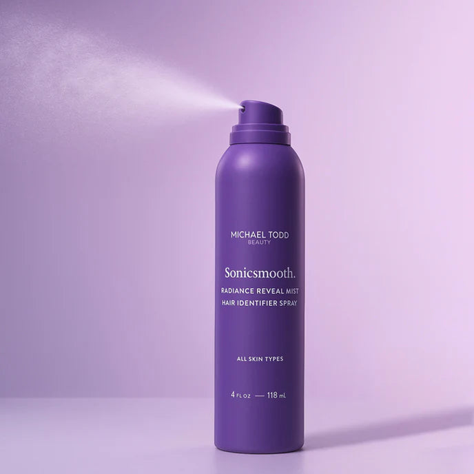 A purple aerosol can of Michael Todd Beauty Hair Identifier Spray is shown spraying against a purple background.