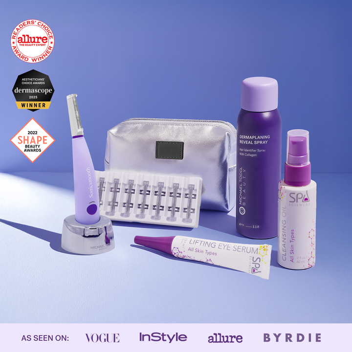 The Michael Todd Beauty Sonicsmooth Starter System includes a face razor, spray bottles, serum, replacement blades, and a silver pouch for peach fuzz removal, all displayed on a purple surface with award badges.