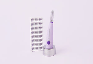 A purple Michael Todd Beauty Sonicsmooth Basic device stands on a charging base beside a tray with eight replacement heads, all set against a light background.