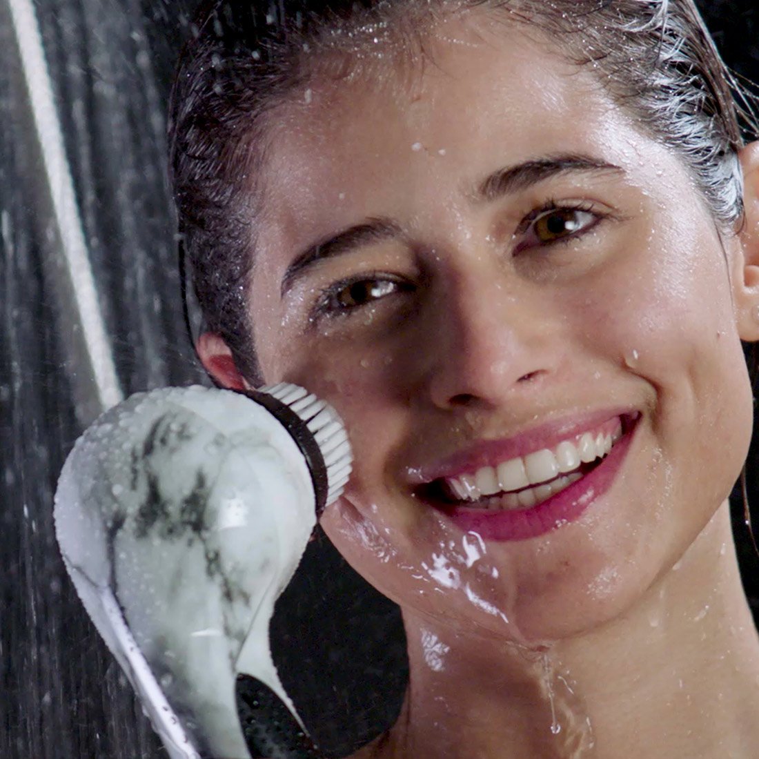 A woman with a flawless look smiling in the shower, showcasing her clean complexion using the Stay Balanced by Michael Todd Beauty.
